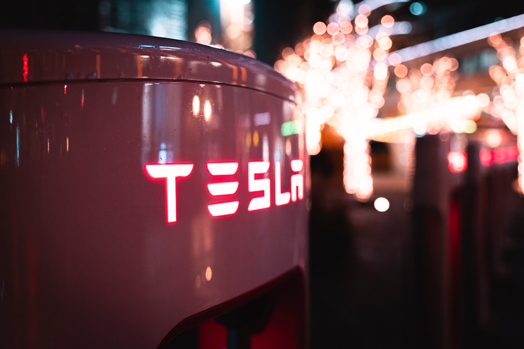 a close up of a tesla logo on the side of a car
