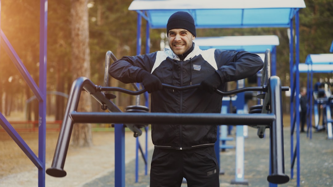 Man exercising on outdoor gym equipment